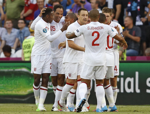 England's Joleon Lescott, second left, celebrates with teammates after scoring during the Euro 2012 soccer championship Group D match between France and England in Donetsk, Ukraine, Monday, June 11, 2012. (AP Photo/Kirsty Wigglesworth)