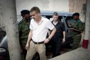 FILE- Norwegian citizens Tjostolv Moland, left, and Joshua French, right, arriving for their trial process in Kisangani, Congo, in this file photo dated Thursday Dec. 3, 2009, on charges of killing their driver Abedi Kasongo, espionage, armed robbery and organised crime. According to government officials and his lawyer Sunday Aug. 18, 2013, Moland has died in prison, aged 32. The cause of death wasn't immediately clear, attorney Hans Marius Graasvold said, while also declaring that British-Norwegian citizen Joshua French, who was imprisoned alongside Moland, is upset but in good health. (AP Photo, FILE) NORWAY OUT
