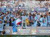 Manchester City's team members celebrate with the English Premier League trophy after their match against Queens Park Rangers at the Etihad Stadium, Manchester, England, Sunday May 13, 2012. (AP Photo/Jon Super)