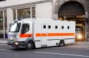 A police prison transport van leaves court in London on December 19, 2013