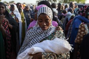 Nigerian women queue to receive humanitarian aid in &hellip;