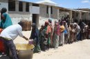 Children receive food ration at a feeding centre in the southern Mogadishu in April