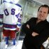 Mike Eruzione, captain of the 1980 gold medal winning U.S. Olympic ice hockey team poses next to the jersey and uniform he wore when the U.S. defeated the Soviet Union in what is known as the "Miracle on Ice" at Heritage Auctions in New York City