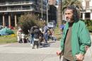 Former Guantanamo inmate Syrian Jihad Diyab walks in front of Syrian refugees as they camp at Independence square in Montevideo on September 8, 2015 to demonstrate
