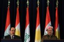 Iraqi Prime Minister Nouri al-Maliki, left, and Kurdish regional President Massoud Barzani, attend a press conference after a cabinet meeting in Irbil, 350 kilometers (217 miles) north of Baghdad, Iraq, Sunday, June 9, 2013. Iraq's Prime Minister on Sunday made a rare visit to the country's self-ruled northern Kurdish region in a bid to melt the ice between the Kurds and the Shiite-led central government in Baghdad, as a suicide attack in Baghdad claimed the lives of seven people. (AP Photo/Ceerwan Aziz)
