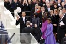 U.S. President Barack Obama takes the oath from U.S. Supreme Court Justice John Roberts as his wife Michelle Obama and daughters Malia Obama and Sasha Obama watch during swearing-in ceremonies on the West front of the U.S Capitol in Washington
