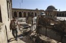 A Free Syrian Army fighter walks inside the Grand Umayyad mosque in Aleppo
