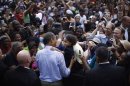 U.S. President Barack Obama meets a young girl in the audience during a campaign rally in Glen Allen