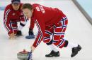 Norway's Torger Nergaard, right, sweeps ahead of a shot by skip Thomas Ulsrud during a men's curling training session the 2014 Winter Olympics, Sunday, Feb. 9, 2014, in Sochi, Russia. (AP Photo/Robert F. Bukaty)