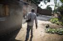 An armed man walks through the alleys of the Muslim neighbourhood of the PK5 district in Bangui on June 2, 2014