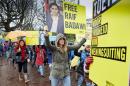 People take part in a protest by Amnesty International calling for the immediate release of Saudi blogger Raif Badawi, outside the Saudi Embassy in The Hague, on January 15, 2015
