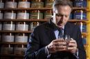 Schultz, chief executive of Starbucks, smells a cup of tea as he poses for a portrait at his new Teavana store in New York