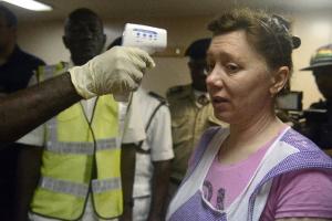 Nigerian health officials takes the body temperature &hellip;