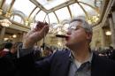 FILE - In this Jan. 21, 2011 file photo, Peter Zavialoff of the The Wine House wine store in San Francisco, samples a glass of Chateau La Tour de By during the Union of Grand Crus 2008 vintage wine tasting in the Garden Court of the Palace Hotel in San Francisco. Americans hoping to save on European goods thanks to a falling euro shouldn't celebrate just yet. There's simply too much demand in the U.S. for any markdowns. (AP Photo/Eric Risberg, File)