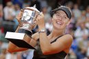Maria Sharapova of Russia holds the trophy after winning the women's final match against Sara Errani of Italy at the French Open tennis tournament in Roland Garros stadium in Paris, Saturday June 9, 2012. Sharapova won in two sets 6-3, 6-2. (AP Photo/Michel Euler)