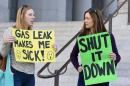 Porter Ranch residents hold signs outside Los Angeles City Hall during a demonstration on the ongoing natural gas leak in the Porter Ranch area of Los Angeles