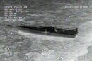 A stricken sailboat, the Uncontrollable Urge, is pictured near San Clemente Island, California in this still image capture from an infrared Coast Guard handout video