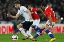 England's midfielder Adam Lallana (L) clashes with Chile's forward Alexis Sanchez during the international friendly football match against Chile at Wembley in north London on November 15, 2013