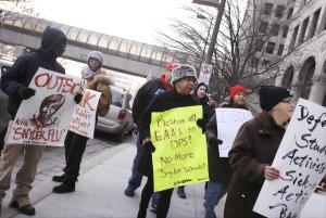 Protesters stand outside Cadillac Place, Monday, Jan.&nbsp;&hellip;