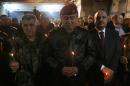 An Iraqi general attends a Christmas Eve service for Iraqi Christians at the Mar Shimoni church in the town of Bartalla near Mosul, on December 24, 2016
