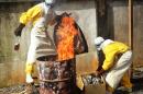 Health workers burn used protective gear at the Medecins Sans Frontieres center in Conakry on September 13, 2014