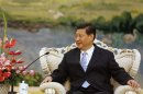 File photo of China's Vice President Xi listening to U.S. Secretary of Defense Panetta in Beijing