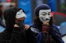 Demonstrators with Guy Fawkes masks are seen in London on November 15, 2011