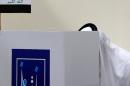 An Iraqi national residing in the UAE casts his ballot for Iraq's parliamentary elections at a polling station in Dubai on April 27, 2014
