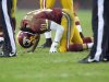 Washington Redskins quarterback Robert Griffin III kneels on the ground after an injury during the second half of an NFL football game against the Baltimore Ravens in Landover, Md., Sunday, Dec. 9, 2012. (AP Photo/Nick Wass)