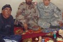 This 2008 photo provided by Stephen Lee shows Lee, right, having a meal with Afghans in Paktika province, Afghanistan. Lee was still in Afghanistan - his second deployment to the war zone - when he began looking at colleges. The California native settled on the University of Wisconsin-Madison and had already begun his studies when he learned of the coming changes to his GI Bill benefits. He was looking at an extra $20,000 a year out of pocket. "It was a HUGE jump," says Lee, whose military occupational specialty, or MOS, was human intelligence collector. "And that's when I had to start thinking really hard about whether or not I was going to be able to afford school, or whether I'd have to take a year off and work while I tried to get in-state status." Around that time, the state launched its Yellow Ribbon Program, under which the university and the VA agree to split the difference between the resident and nonresident rate. There was only a limited amount set aside for the program, but Lee lucked out. "This uncertainty almost took me out of school," he says. (AP Photo/Stephen Lee)
