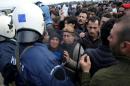 Migrants argue with police near the Greek-Macedonian border, near the village of Idomeni