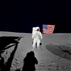 This undated NASA image obtained February 5, 2016 shows Astronaut Edgar D. Mitchell, Apollo 14 lunar module pilot standing by the deployed U.S. flag on the lunar surface during the early moments of the mission&#39;s first spacewalk