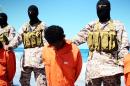 Men described as Ethiopian Christians captured in Libya kneeling on the ground in front of masked militants before their beheading on a beach at an undisclosed location in Libya