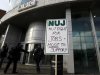 A National Union of Journalists, NUJ, placard taped to a post outside the BBC Television Centre in White City, London,  Monday, Feb. 18, 2013. BBC journalists have gone on strike for 24 hours after the NUJ failed to reach an agreement with management in a disagreement over redundancies. (AP Photo/Kirsty Wigglesworth)