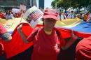 Health workers who support Venezuelan President Nicolas Maduro march to the presidential palace in Caracas on March 10, 2014