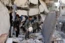 In this citizen journalism image provided by Aleppo Media Center (AMC), an anti-Bashar Assad activist group, which has been authenticated based on its contents and other AP reporting, Syrians inspect the rubble of destroyed buildings following a Syrian government airstrike in Aleppo, Syria, Friday, Jan. 31, 2014 . Activists said the latest Syrian government shelling has killed and wounded several people in a rebel-held area of the northern city of Aleppo. (AP Photo/Aleppo Media Center, AMC)