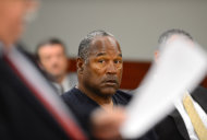 O.J. Simpson looks over at his lawyer Tom Pitaro during an evidentiary hearing in Clark County District Court on May 17, 2013 in Las Vegas. Simpson, who is currently serving a nine-to-33-year sentence in state prison as a result of his October 2008 conviction for armed robbery and kidnapping charges, is using a writ of habeas corpus to seek a new trial, claiming he had such bad representation that his conviction should be reversed. (AP Photo/Ethan Miller, Pool)