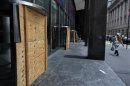 Plywood covers the revolving doors in preparation for Hurricane Sandy at the 2 Broadway building of Lower Manhattan in New York, Sunday, Oct. 28, 2012. Areas along the Northeast Coast are preparing for the arrival of the hurricane and a possible flooding storm surge. (AP Photo/Craig Ruttle)