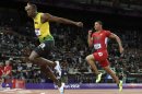 Jamaica's Usain Bolt, left, crosses the finish line ahead of Ryan Bailey of the United States in the men's 4x100-meter relay final during the athletics in the Olympic Stadium at the 2012 Summer Olympics, London, Saturday, Aug. 11, 2012. Jamaica set a new world record with a time of 36.84 seconds. (AP Photo/David J. Phillip)