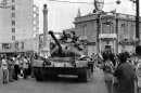 FILE - In this on July 24, 1974 file photo a Turkish army tank passes the Saray Hotel in the Turkish section of Nicosia, Cyprus, On the roof of a nearby building is a picture of Kemal Ataturk, founder of the modern Turkish republic. The 1974 invasion was sparked by an abortive coup by supporters of union with Greece. It led to the occupation by Turkey of the northern third of Cyprus and some 200,000 Greek Cypriots fleeing or being expelled from their homes in the north. The current spat between the EU and Russia over the future of its economy underlines the small Mediterranean island has played an outsized role in history. (AP Photo, File)
