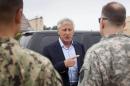 Defense Secretary Chuck Hagel speaks with members of his military staff before boarding his plane prior to his departure from Andrews Air Force Base, Md., Wednesday, May 28, 2014. Hagel is traveling on a 12-day trip to Asia and Europe, his fourteenth international trip, to discuss key regional and global issues with leaders of several countries. (AP Photo/Pablo Martinez, Pool)