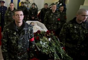 Ukrainian soldiers stand around the coffin of Sergey …