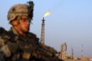 A US soldier stands guard in front of the Iraqi Northern Oil Refinery near the town of Baiji, on November 10, 2007