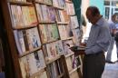 An Iraqi man browses a book at a library in Baghdad, Iraq, on June 27, 2014
