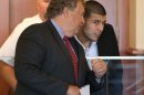 Former New England Patriots player Aaron Hernandez, right, listens to his lawyer, Michael Fee, left, during his arraignment in superior court Friday, Sept. 6, 2013, in Fall River, Mass. Hernandez faces a murder charge in the death of Odin Lloyd, 27, whose body was found by a jogger on June 17 in an industrial park in North Attleborough, Mass., about a mile from Hernandez's home. (AP Photo/The Boston Globe, Jonathan Wiggs, Pool)
