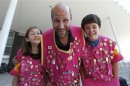 Daniel Presburger of Los Angeles and his 12-year-old twins pose for photograph outside Olympic Village in London