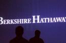 Berkshire Hathaway shareholders walk by a video screen at the company's annual meeting in Omaha
