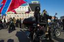A biker sporting a Novorossiya (new Russia) flag drives through the crowd during a concert in Donetsk's main square on October 4, 2014