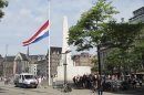 A flag is flying at half-staff at Dam Square in Amsterdam, Friday, Aug. 16, 2013. Members of the Dutch royal family and a small collection of friends are attending a private funeral for Prince Friso, who died this week due to complications from a 2012 skiing accident. He died on Monday, aged 44. Flags are flying at half-staff on official buildings around the country, and thousands of Dutch people have sent messages of condolences via social media. Friso is survived by his wife, Princess Mabel, and two young daughters. (AP Photo/Margriet Faber)