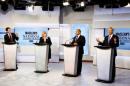 Liberal leader Justin Trudeau, Green Party leader Elizabeth May and New Democratic Party leader Thomas Mulcair listen as Conservative Leader Stephen Harper speaks during the first leaders' debate in Toronto